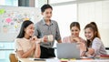 A group of happy Asian tech developers is in the meeting, brainstorming on a new UI and UX project Royalty Free Stock Photo