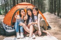 Group of happy Asian teenage girls doing victory pose together, camping by the tent. Outdoor activity, adventure travel concept Royalty Free Stock Photo