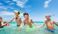 Group of happy boys in scuba mask run into the sea Royalty Free Stock Photo