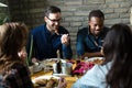 Group of happy business people eating in restaurant