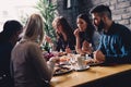 Group of happy business people eating in restaurant