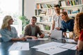 Group of happy business people working together on project in office. Royalty Free Stock Photo