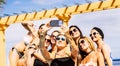 Group of happy and cheerful young caucasian women have fun together in friendship taking selfie picture during summer holiday Royalty Free Stock Photo