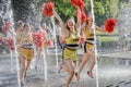 Group of happy Cheerleaders enjoy jogging through the fountain