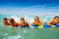 Group of happy children boy, girls splash in sea