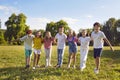 Group of happy children enjoying summer holidays and playing in green park all together Royalty Free Stock Photo