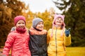 Group of happy children hugging in autumn park Royalty Free Stock Photo