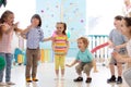 Group of happy children jump indoor. Kids play together