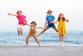 Group of happy children jump by   sea in summer Royalty Free Stock Photo