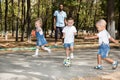 Group of happy children playing with soccer ball in park on nature at summer Royalty Free Stock Photo