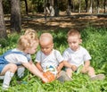 Group of happy children playing with soccer ball in park on nature at summer. Royalty Free Stock Photo