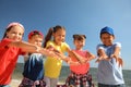 Group of happy children at sea beach on sunny day. Summer camp Royalty Free Stock Photo