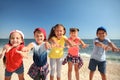 Group of happy children at sea beach on sunny day. Summer camp Royalty Free Stock Photo