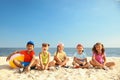 Group of happy children sitting on sand at sea beach. Summer camp Royalty Free Stock Photo