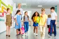 group of happy classmates walking