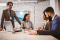 Happy colleagues talking while having business meeting in the office Royalty Free Stock Photo