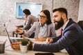 Happy colleagues talking while having business meeting in the office Royalty Free Stock Photo