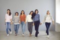 Group of happy confident supportive young women walking hand in hand and smiling Royalty Free Stock Photo