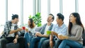 Group of happy creative team talking while taking coffee break at office Royalty Free Stock Photo