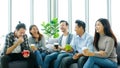 Group of happy creative team talking while taking coffee break at office Royalty Free Stock Photo