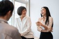 Group of happy diverse Asian businesspeople colleagues are enjoying talking during a coffee break Royalty Free Stock Photo