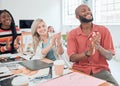 Group of happy diverse businesspeople having a meeting in a modern office at work. Joyful colleagues clapping hands for Royalty Free Stock Photo