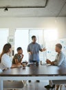 Group of happy diverse businesspeople having a meeting in an office at work. Young african american businessman talking Royalty Free Stock Photo