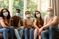 Group of happy diverse female and male friends in face masks showing plasters after vaccination Royalty Free Stock Photo