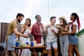 Group of happy diverse friends having fun at barbecue party outdoor in backyard Royalty Free Stock Photo