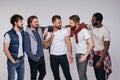 Group of happy diverse men in casual urban style clothes posing at camera Royalty Free Stock Photo