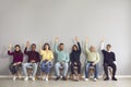 Group of happy diverse people raising hands unanimously voting for suggested idea Royalty Free Stock Photo