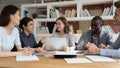 Group of happy diverse students discussing school project together. Royalty Free Stock Photo