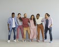 Group of happy diverse young people in casual clothes standing together and laughing