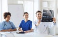 Group of happy doctors discussing x-ray image Royalty Free Stock Photo