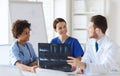 Group of happy doctors discussing x-ray image Royalty Free Stock Photo