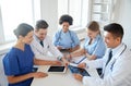 Group of happy doctors meeting at hospital office