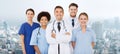 Group of happy doctors over blue background