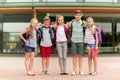 Group of happy elementary school students hugging