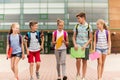 Group of happy elementary school students walking