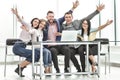 Group of happy employees sitting at the Desk.