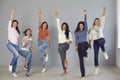 Group of happy confident young women jumping for joy and celebrating team success Royalty Free Stock Photo