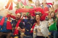 Group of happy fans are cheering for their team victory. Collage made of 9 models. Royalty Free Stock Photo