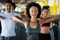 Group of happy multiracial friends exercising together in gym Royalty Free Stock Photo