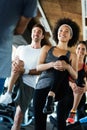 Group of happy multiracial friends exercising together in gym Royalty Free Stock Photo