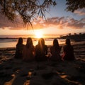 Group of happy friends chatting in front of the sunset with their backs to the camera. Travel, people, leisure and teenager. Royalty Free Stock Photo