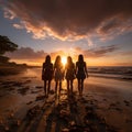 Group of happy friends chatting in front of the sunset with their backs to the camera. Travel, people, leisure and teenager. Royalty Free Stock Photo