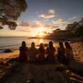 Group of happy friends chatting in front of the sunset with their backs to the camera. Travel, people, leisure and teenager.