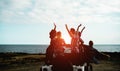 Group of happy friends doing excursion on desert in convertible 4x4 car - Young people having fun traveling together - Friendship Royalty Free Stock Photo