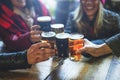 Group of happy friends drinking and toasting beer at brewery bar restaurant - Friendship concept with young people having fun Royalty Free Stock Photo