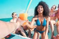 Group of happy friends drinking tropical cocktails at boat party outdoor - Young people having fun in caribbean sea tour - Youth Royalty Free Stock Photo